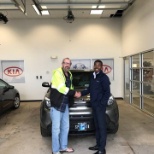 Sales Associate, Brandon making customer Mr. Gregory very happy with his new 2016 Soul!