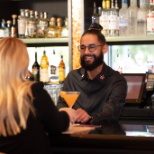 Bartender serving guest