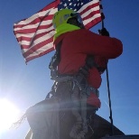 Tower tech hoists American flag. https://tilsontech.com/careers/veterans-program