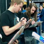 Software engineers and former interns assisting the recruiting team at a career fair