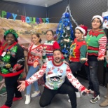 Having some holiday fun with ugly sweaters and a holiday luncheon.